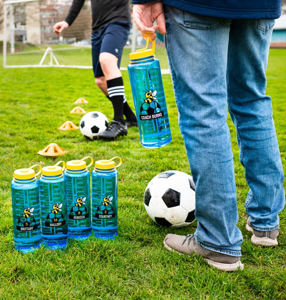 Branded Nalgene water bottles on a soccer field