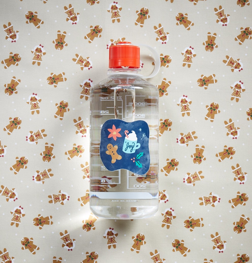 image of a nalgene water bottle with holiday images on it and a background of gingerbread people