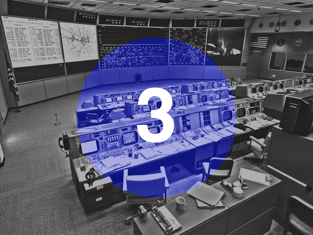 Image of 60s style Nasa control center in black and white. Blue, transparent circle in the middle with a countdown that says "3, 2, 1, Launch"