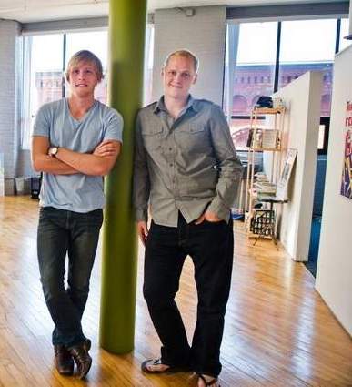 Greg and Josh stand in their old Rochester office, in 2012.